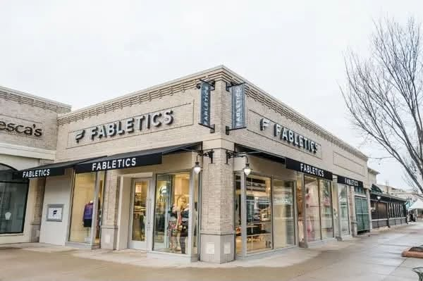 Refreshed brick retail storefront with new signage and awnings